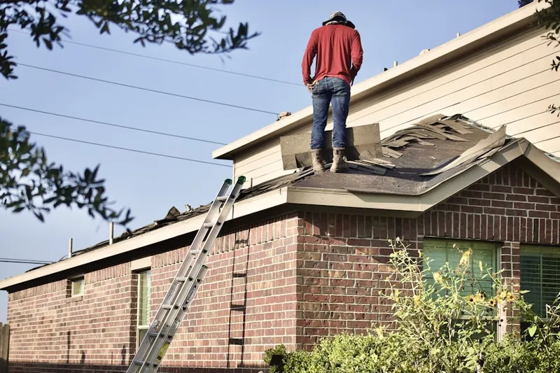 Professional roofer working on a residential roof in Folly Beach